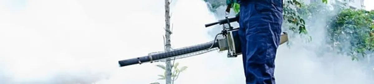 Pest control technician fogging an outdoor area for insect control in Fargo, ND