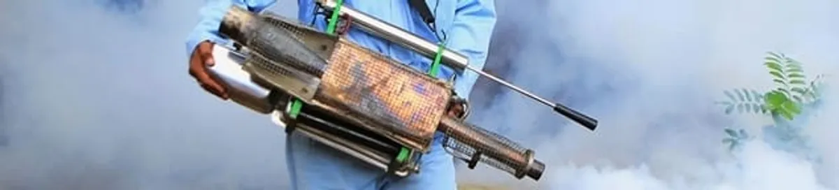 Fumigation technician using a fogger for deep pest treatment in Fargo, ND